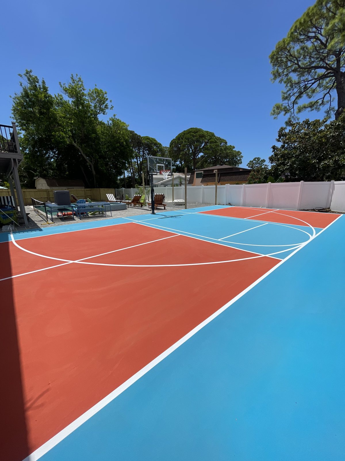 Multi-sport backyard court with hoop and net